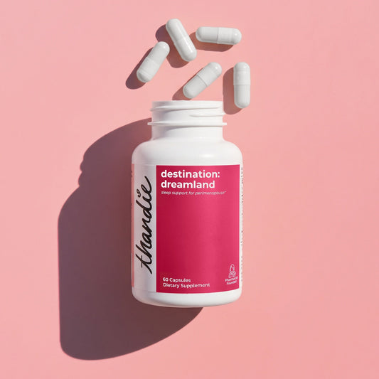 Thandie destination: dreamland sleep support supplement bottle with white capsules on a pink background